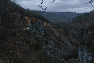 Rocky landscape of the Voidomatis Potamos valley in the Zagoria region at Pindus Mountains on a dark winter day with atmospheric mood, Epirus, Greece