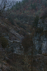 Rocky landscape of the Voidomatis Potamos valley in the Zagoria region at Pindus Mountains on a dark winter day with atmospheric mood, Epirus, Greece