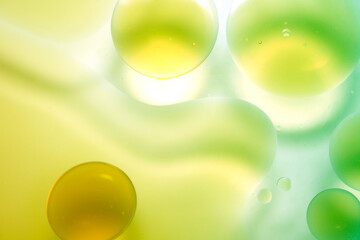 Abstract Oil Droplets and Colorful Liquid Background in Green Tones