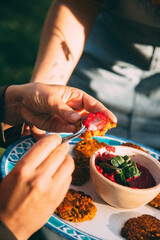 hands holding a bowl of spices