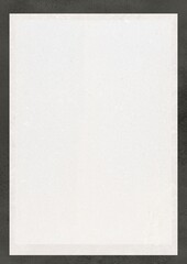 Blank white sheet of paper on dark background