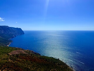 fantastic blue seascape, rocky sea coast, blue sea and blue sky