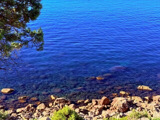fantastic blue seascape, rocky sea coast, blue sea and blue sky