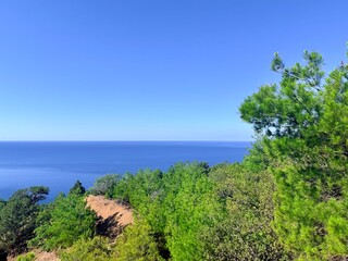 fantastic blue seascape, rocky sea coast, blue sea and blue sky