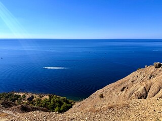 fantastic blue seascape, rocky sea coast, blue sea and blue sky