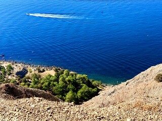 fantastic blue seascape, rocky sea coast, blue sea and blue sky