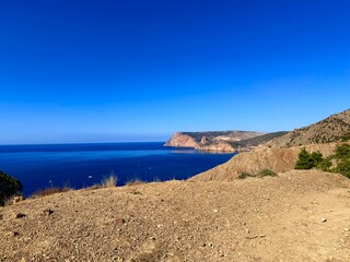 fantastic blue seascape, rocky sea coast, blue sea and blue sky