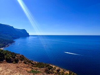 fantastic blue seascape, rocky sea coast, blue sea and blue sky