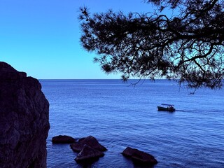 fantastic blue seascape, rocky sea coast, blue sea and blue sky