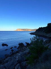 fantastic blue seascape, rocky sea coast, blue sea and blue sky