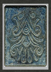Decorative blue glazed tile with embossed floral pattern