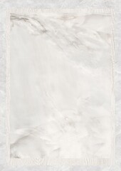 Close-up of white marble surface with subtle gray veining and textured border