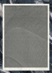 Close-up of a textured gray fabric with a woven pattern, framed against a marbled background.