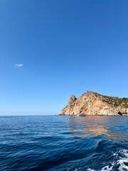 fantastic blue seascape, rocky sea coast, blue sea and blue sky