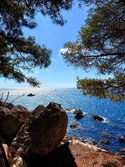 fantastic blue seascape, rocky sea coast, blue sea and blue sky