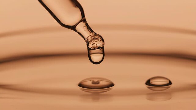 A glass pipette with a drop of clear liquid about to fall into a shallow dish with a warm, amber hue vector illustration