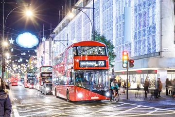 Fototapete Londoner Roter Bus Classic London red bus navigates through a brightly lit street with Christmas decorations and busy foot traffic. Ideal for travel, holiday, or urban lifestyle themes.  © Alexey Fedorenko
