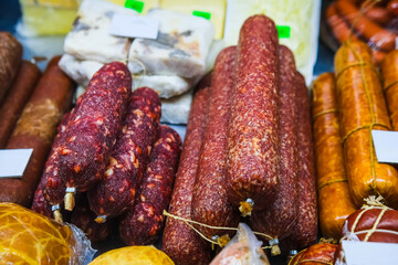 A showcase with various types of sausage and meat products.
