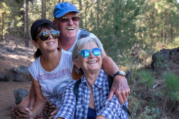 Portrait of happy smiling group of seniors people enjoying a mountain hike in the forest appreciating leisure and freedom, beautiful retired and healthy lifestyle concept