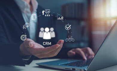 Concept of CRM system and customer relationship technology. Business professional using laptop in...