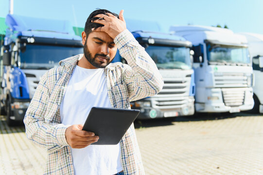 Stressed truck driver managing logistics with a tablet