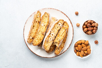 Biscotti, traditional italian bakery with nuts mix. Top view on white background.
