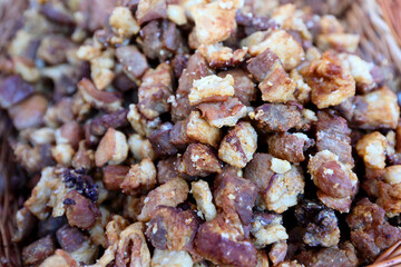 Traditional Romanian Pork Greaves and Lard-prepared on grill at a where various traditional dishes are served at an agricultural fair.
