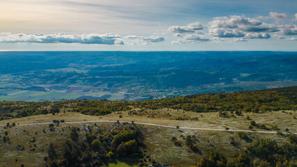 Aerial view of Mount Učka (Ucka) ridge with Vojak peak, winding mountain road, and autumn landscape near Brgud and Mala Učka, Istria, Croatia. Scenic panorama of Učka Nature Park