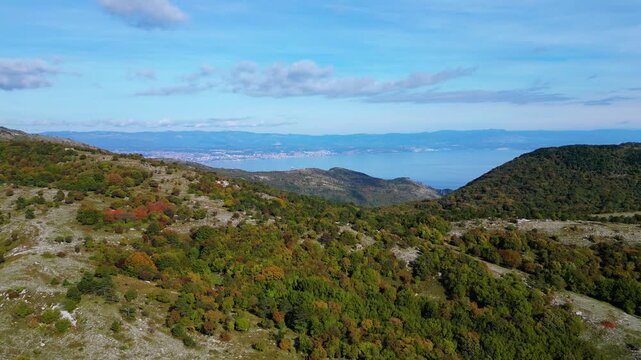 Aerial view of Mount Učka (Ucka) ridge with Vojak peak, winding mountain road, and autumn landscape near Brgud and Mala Učka, Istria, Croatia. Scenic panorama of Učka Nature Park
