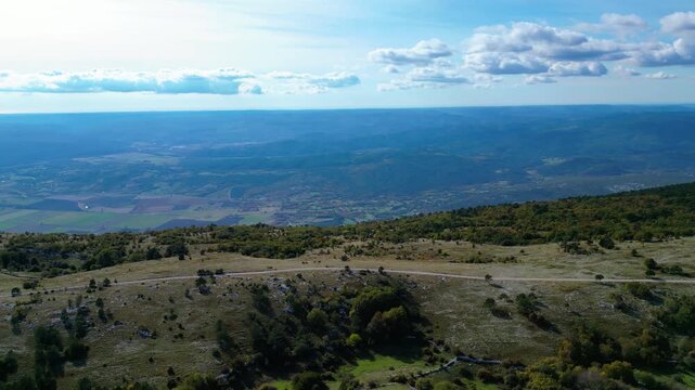 Aerial view of Mount Učka (Ucka) ridge with Vojak peak, winding mountain road, and autumn landscape near Brgud and Mala Učka, Istria, Croatia. Scenic panorama of Učka Nature Park