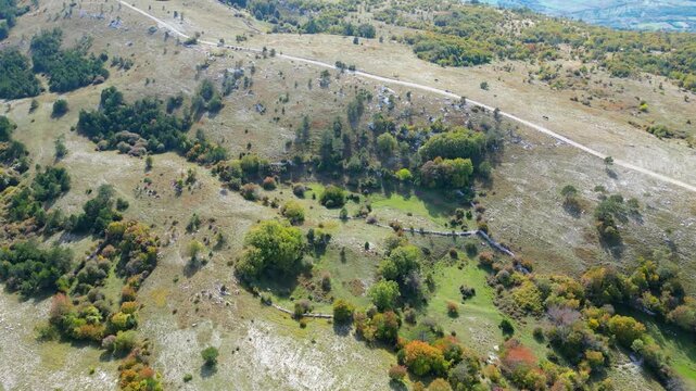 Aerial view of Mount Učka (Ucka) ridge with Vojak peak, winding mountain road, and autumn landscape near Brgud and Mala Učka, Istria, Croatia. Scenic panorama of Učka Nature Park