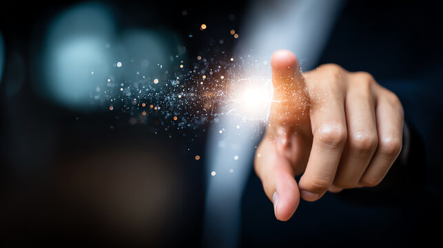 A close-up of a hand pointing with a spark of light, symbolizing innovation and creativity in technology and digital advancements.