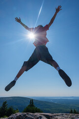 Junger Mann mit einem Freudensprung vor blauem Himmel © Andreas Schuepbach