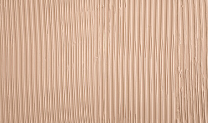 Embossed beige plaster on the wall