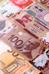 Obraz premium Paper money, banknotes of different countries as a business background. Paper money and cash