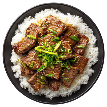 Savory beef cubes atop white rice, garnished with scallions in a black bowl