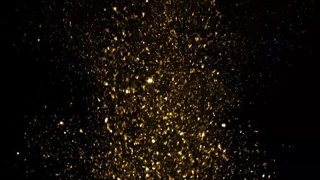 Falling Gold Glitter Particles on Black Background - A still video captures the ethereal beauty of falling gold glitter against a stark black backdrop.