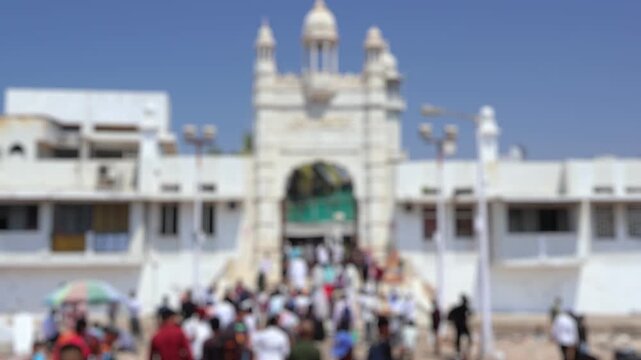 Bokeh view of people visit Haji Ali Dargah in Mumbai, India. Blurred background footage.