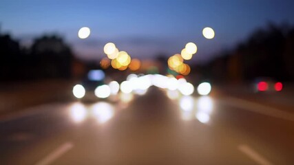 Dreamlike wide video of abstract, shimmering bokeh lights from slow city traffic on urban highway at twilight, gentle dolly forward. Tranquil urban light pattern - Powered by Adobe