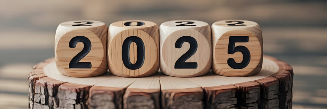 Year 2025 flipping to new Year 2026 on wooden surface.