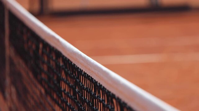 Tennis tournament championship on outdoor clay court with net, professional athletes play in motion with rackets serve tennis ball during tennis match game, tennis training in a sunny day on a stadium - Powered by Adobe