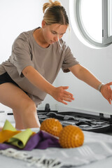 Young Gen Z woman doing barbell workout at home. Concept of mindful fitness, wellness, self-care,...