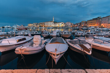 The beautiful old town of Rovinj, with its colorful houses and marina in the foreground. The Croatian resort during the blue hour before sunrise.