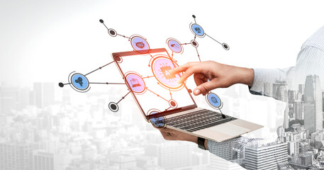 A conceptual image depicting a hand reaching towards a laptop with displayed icons, symbolizing interaction between technology and digital applications in a modern workspace. Tessel