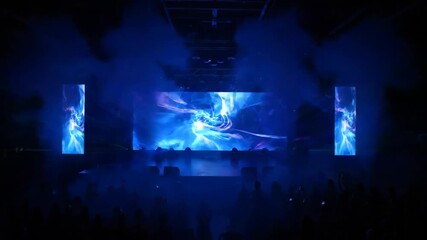 Vibrant Stage Light Show with Smoke - A concert scene with a vibrant stage illuminated by lights and smoke effects. - Powered by Adobe