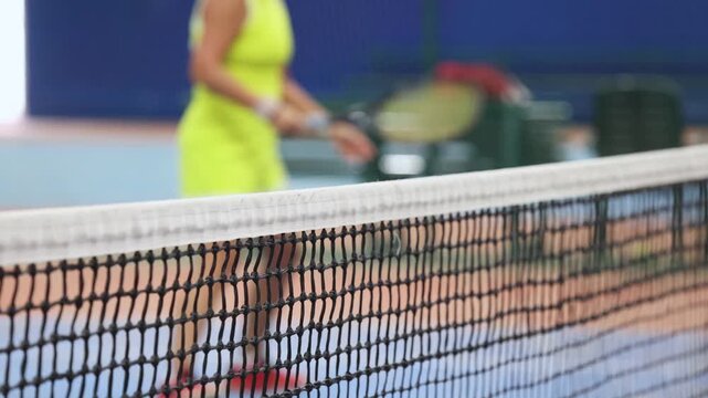 Tennis tournament championship on outdoor clay court with net, professional athletes play in motion with rackets serve tennis ball during tennis match game, tennis training in a sunny day on a stadium