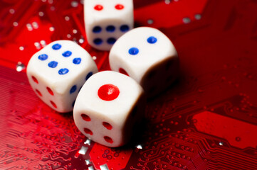 A close-up of the devil's dice lying on an electronic circuit board. The devil's dice are on a microchip.