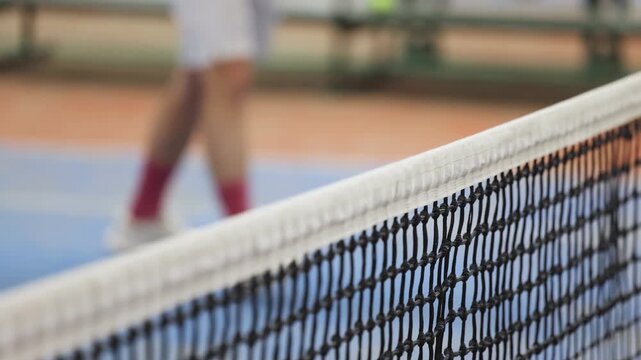 Tennis tournament championship on outdoor clay court with net, professional athletes play in motion with rackets serve tennis ball during tennis match game, tennis training in a sunny day on a stadium
