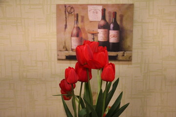 A bouquet of unopened tulip buds set against a softly lit wall