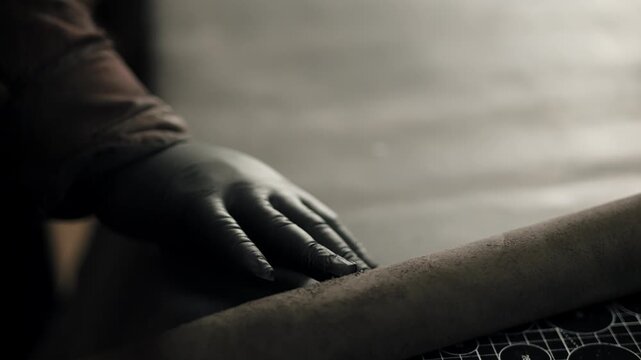 Craftsman working with leather on workbench